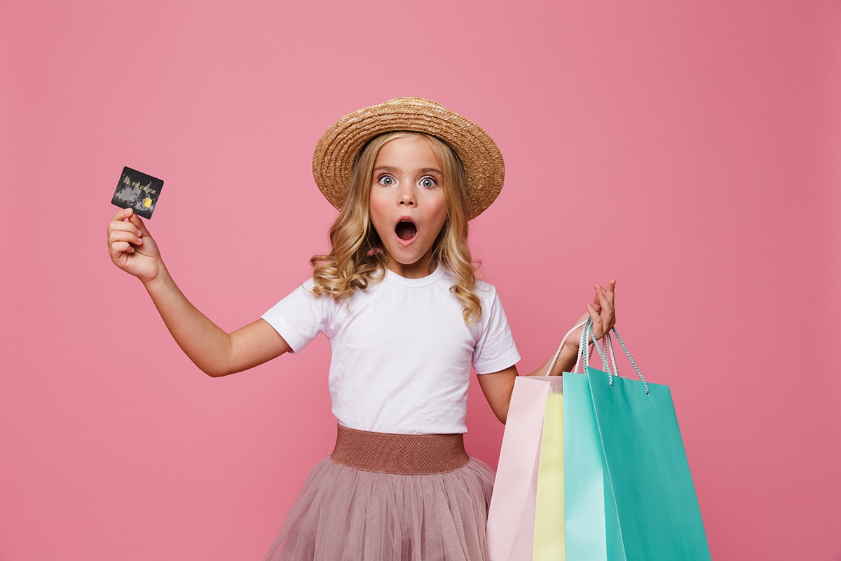 Portrait of a shocked little girl in hat and skirt