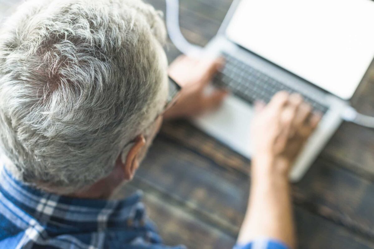 overhead-view-senior-man-using-laptop
