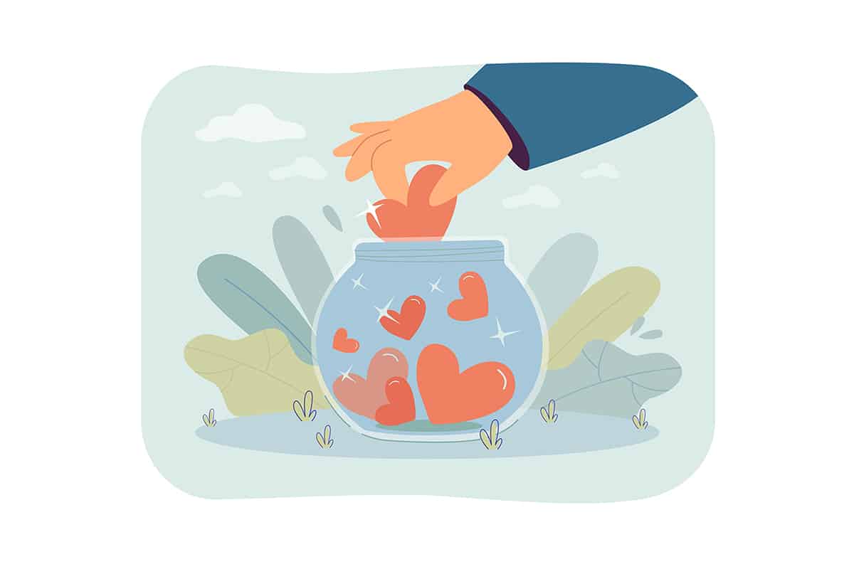 Volunteers hand putting heart in glass donation jar