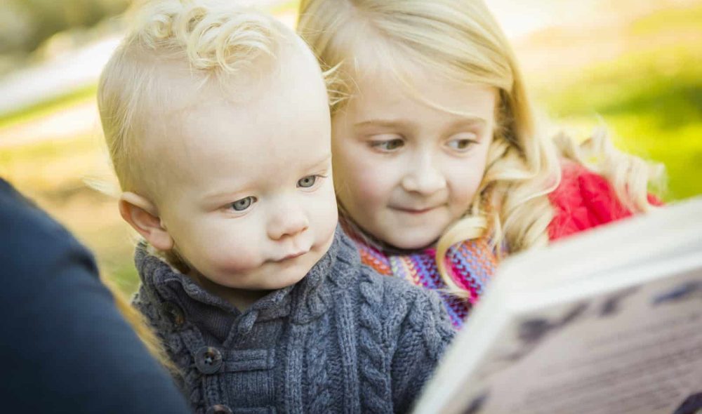 10322724_mother-reading-a-book-to-her-two-adorable-blonde-children