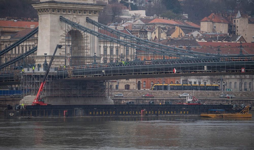Budapest, 2023. március 3.
Hajók segítik a Lánchíd felújítását Budapesten 2023. március 3-án. Ismét bárka dolgozik a Lánchíd lábánál, arról emelik vissza a helyükre a műemléki elemeket, vasöntvény konzolokat és mellvédeket - közölte ezen a napon a Budapesti Közlekedési Központ (BKK) az MTI-vel.
MTI/Balogh Zoltán