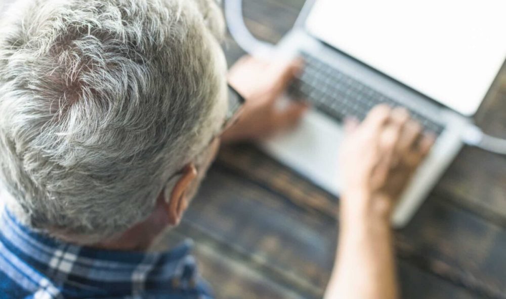 overhead-view-senior-man-using-laptop